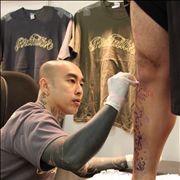 Picture Of Tattoo Artist Drawing A Design