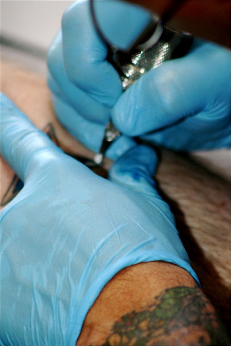 Picture Of Tattoo Artist With Nitrile Gloves And Sterilized Equipment