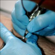 Picture Of Tattoo Artist With Nitrile Gloves And Sterilized Equipment